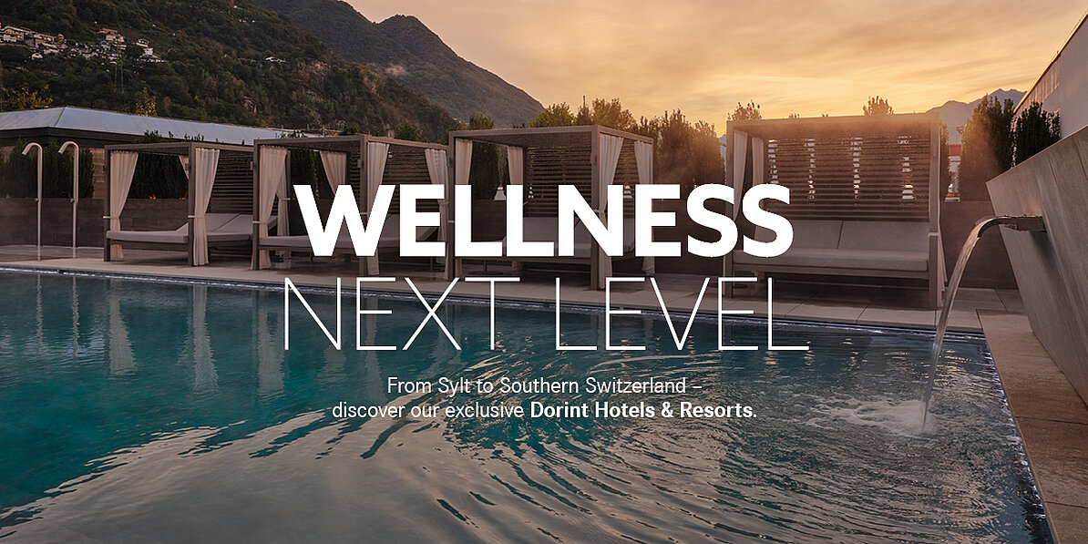 Luxury outdoor spa pool at a Dorint wellness hotel with cabanas and mountain views at sunset