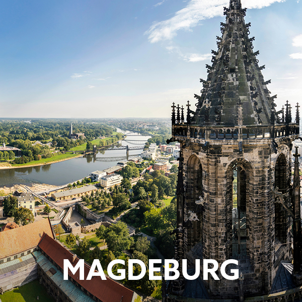 The spire of Magdeburg Cathedral in the foreground and the river in the background