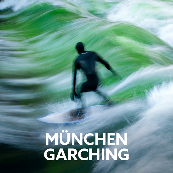 Surfer riding a standing wave in Munich. An active city break with outdoor adventures, sports and leisure activities in the city.