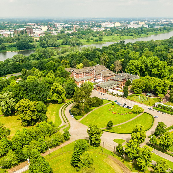 Aerial view of Dorint Herrenkrug Parkhotel Magdeburg surrounded by autumn colours in Herrenkrug Park