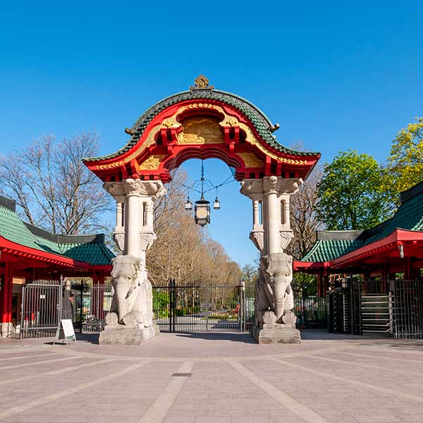 Das Bild zeigt das imposante, im asiatischen Stil gehaltene Eingangstor eines Zoos an einem sonnigen Tag.