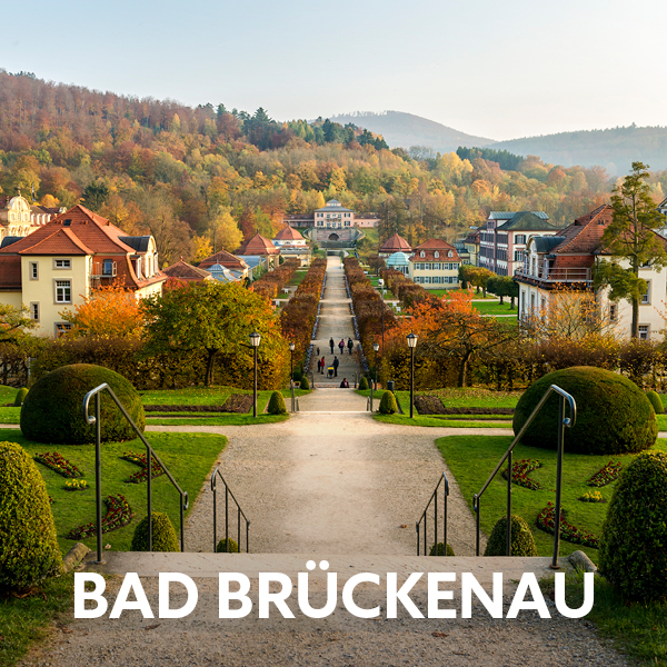 Spa gardens and historic resort buildings in Bad Brückenau surrounded by colourful autumn landscapes.