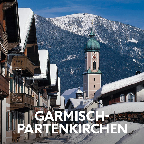 Winter scenery in Garmisch-Partenkirchen with alpine mountains and village for an active holiday getaway.