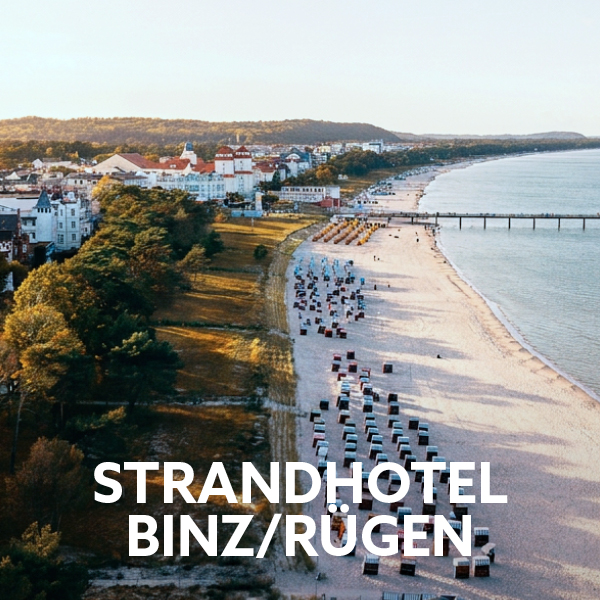 Binz beach on Rügen with beach chairs, seaside promenade and holiday hotel on the Baltic Sea.